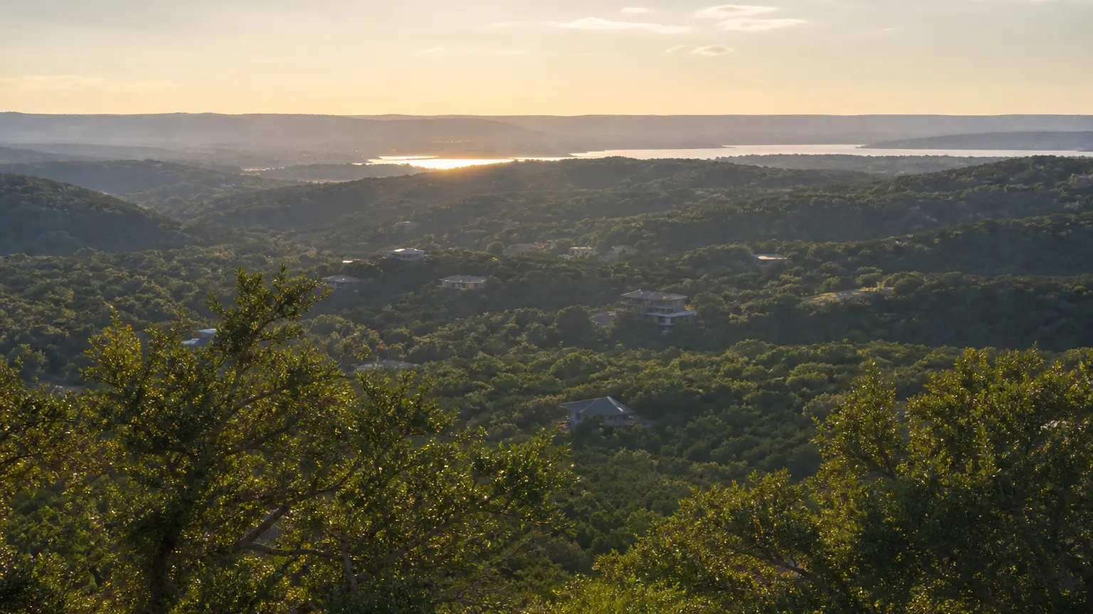 Bee Cave, Texas: view from high over wooded hills toward a distant lake glint